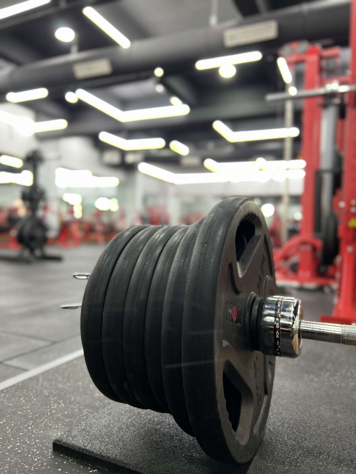 Loaded barbell with gym floor in background